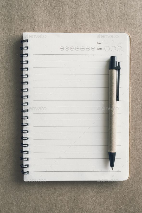Blank notebook and pen on desk office with copy space Note