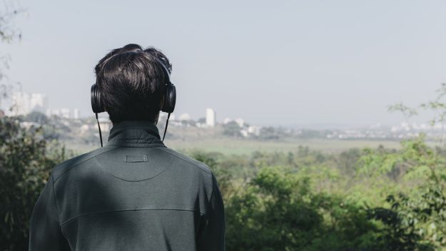 Man listening to music in nature Listening Podcast